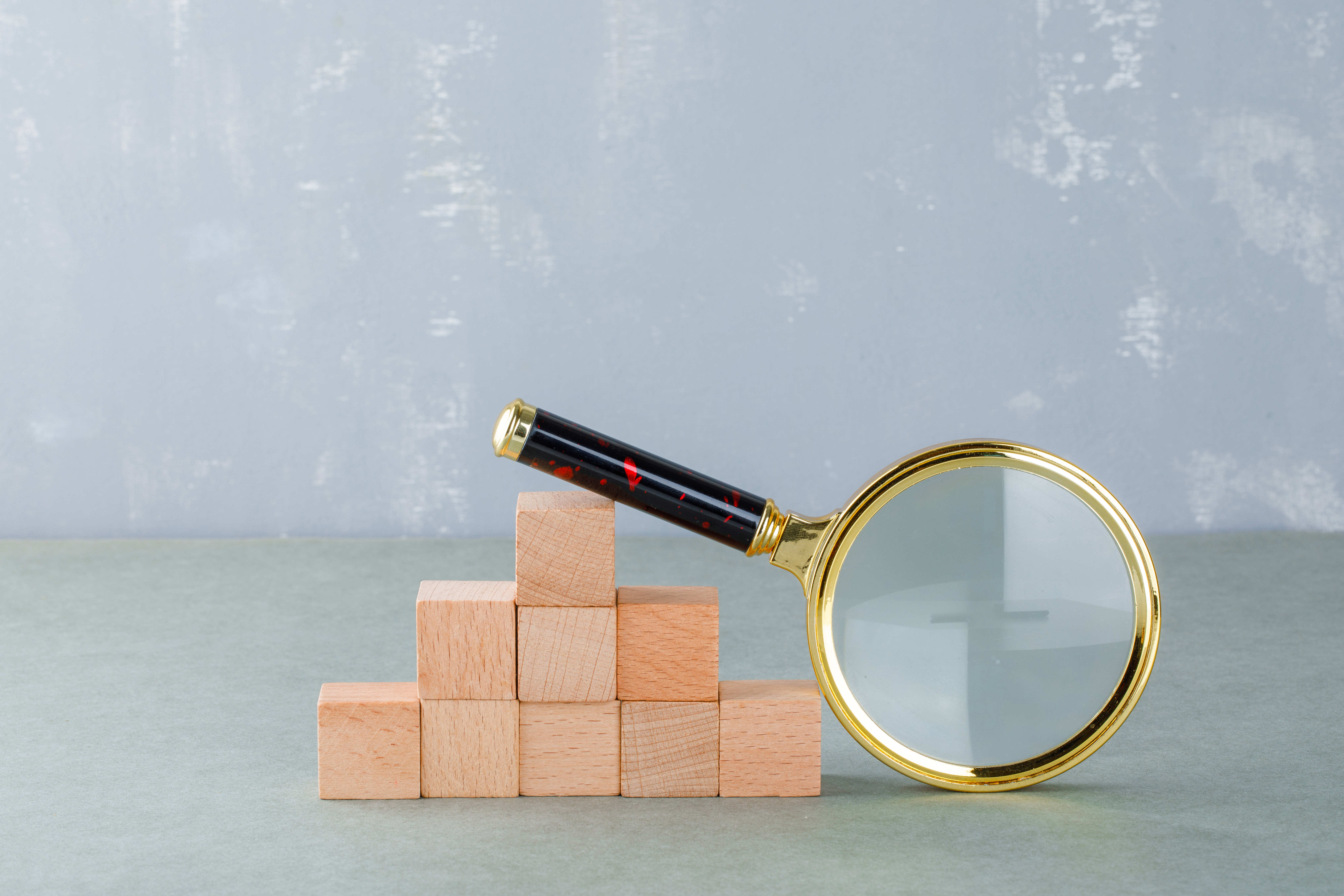 searching-and-business-concept-with-wooden-blocks-magnifying-glass-side-view.jpg